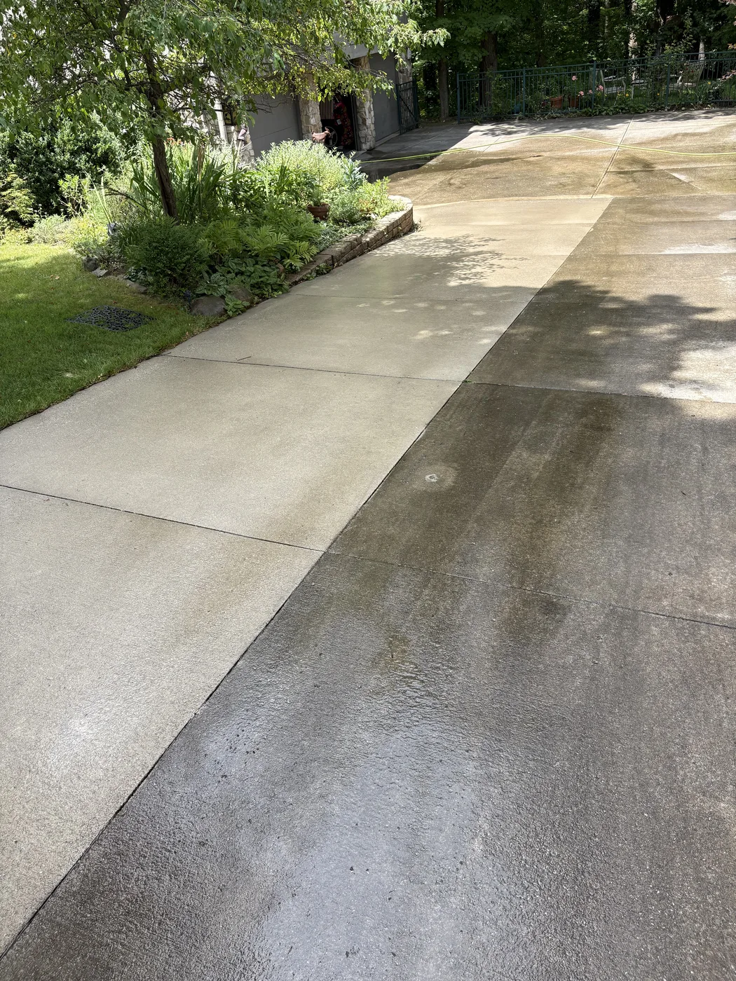 Cleaned and uncleaned sections of a concrete driveway